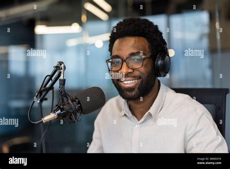 Man speaking into a microphone in a recording studio