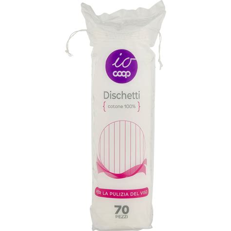 Una bottiglia di latte detergente con dischetti di cotone