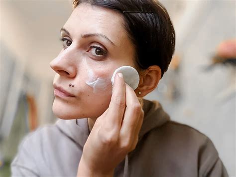 Applicazione del latte detergente con un dischetto di cotone