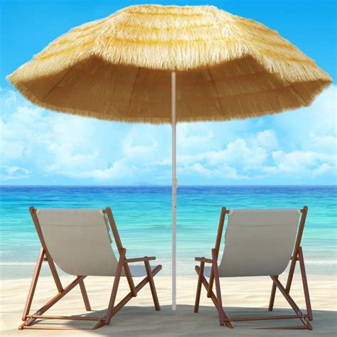 Famiglia in spiaggia con cappelli e ombrellone